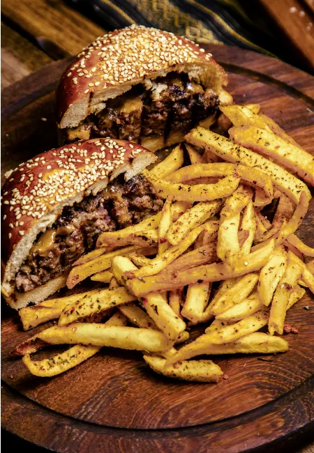 Fresh golden fries served with a Brooklyn Brisket sandwich cut in half and a juicy burger topped with melted cheese.